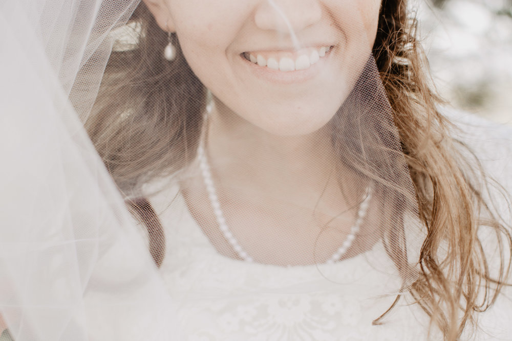 Windy wedding day and bride with the prettiest veil at Logan Utah wedding