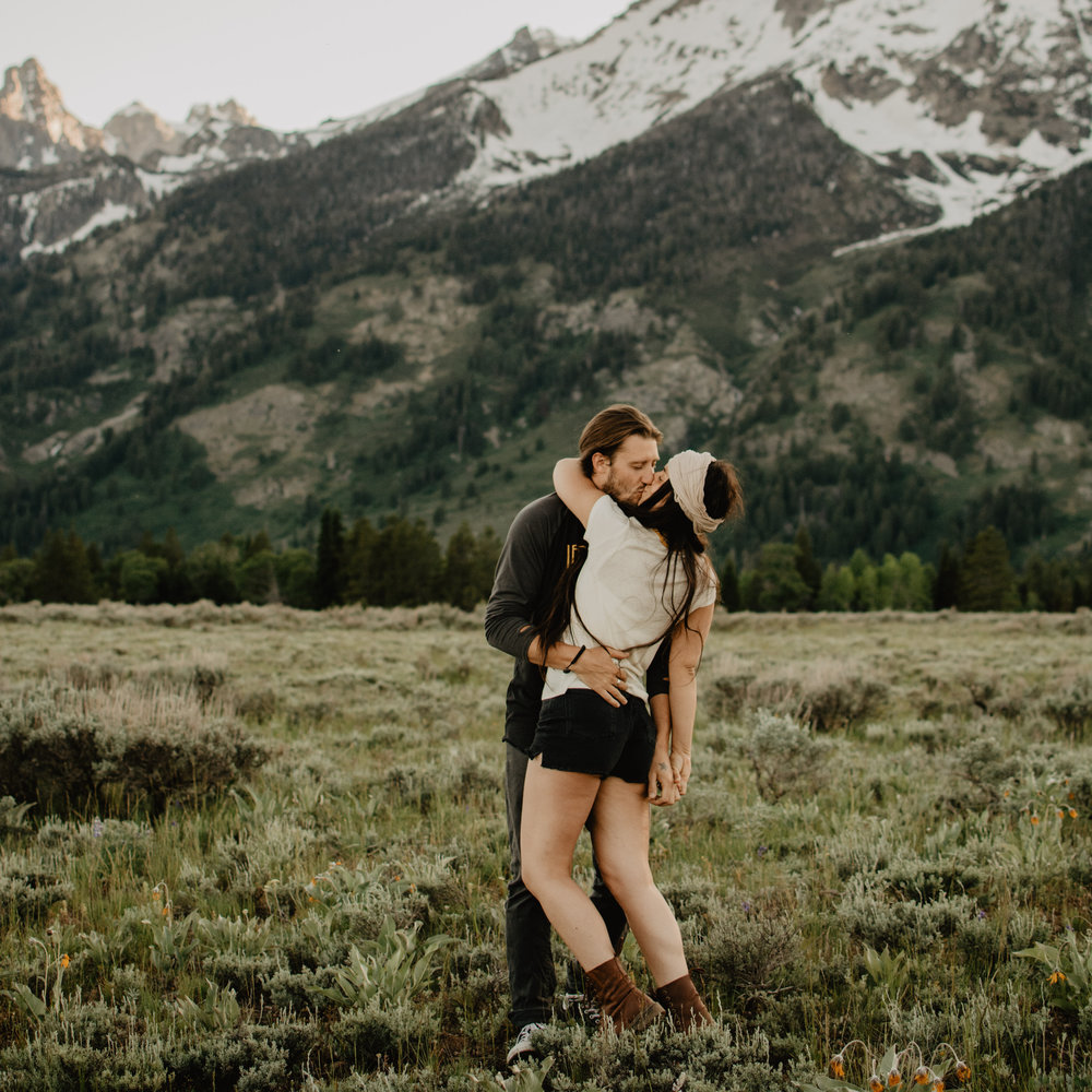 Couple kissing in the Grand Teton National Park for their adventerous engagement session-sq.jpg