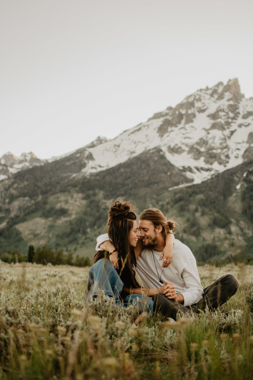 Jocilyn Bennett Photography | Engagement Pose Ideas | Destination Wedding Photographer | Elopement Wedding Photographer | National Park Elopement Photography | Capturing raw and genuine emotion | Wyoming photographer | Wyoming wedding photographer | National Park Weddings | Outfit ideas for engagements | Mountain engagements | Adventure Photographer | Movement photography | Bohemian photography | Bohemian wedding | Jackson Hole Photography | Grand Teton National Park | Couple sitting in the meadow |
