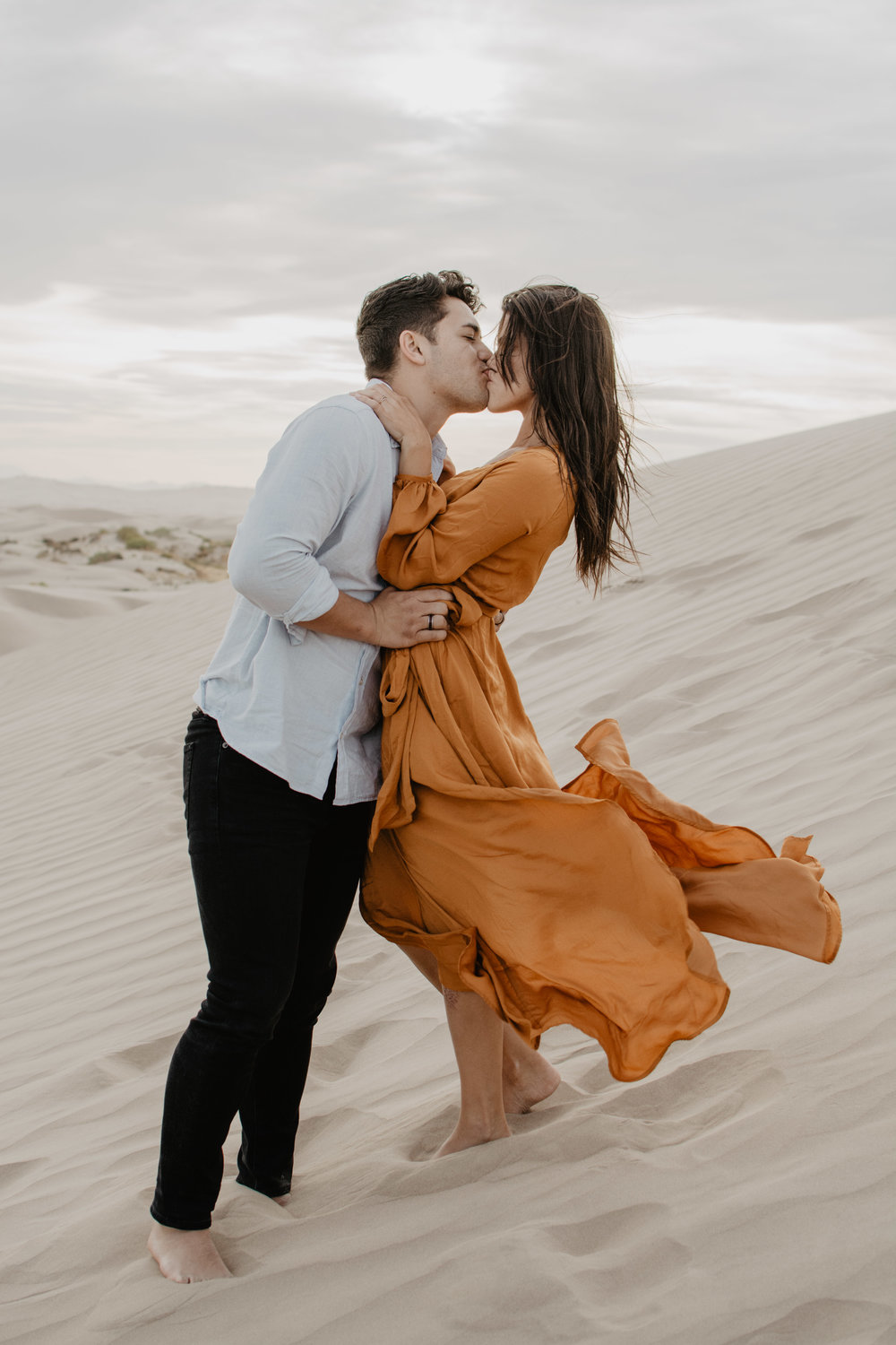 Jocilyn Bennett Photography | Engagement Pose Ideas | Destination Wedding Photographer | Elopement Wedding Photographer | National Park Elopement Photography | Capturing raw and genuine emotion | Utah Photographer | Utah wedding Photographer | National Park Weddings | Outfit ideas for engagements | Engagements with sand | Adventure Photographer | What to wear guide for engagement | Little Sahara engagements | Location ideas for engagements |