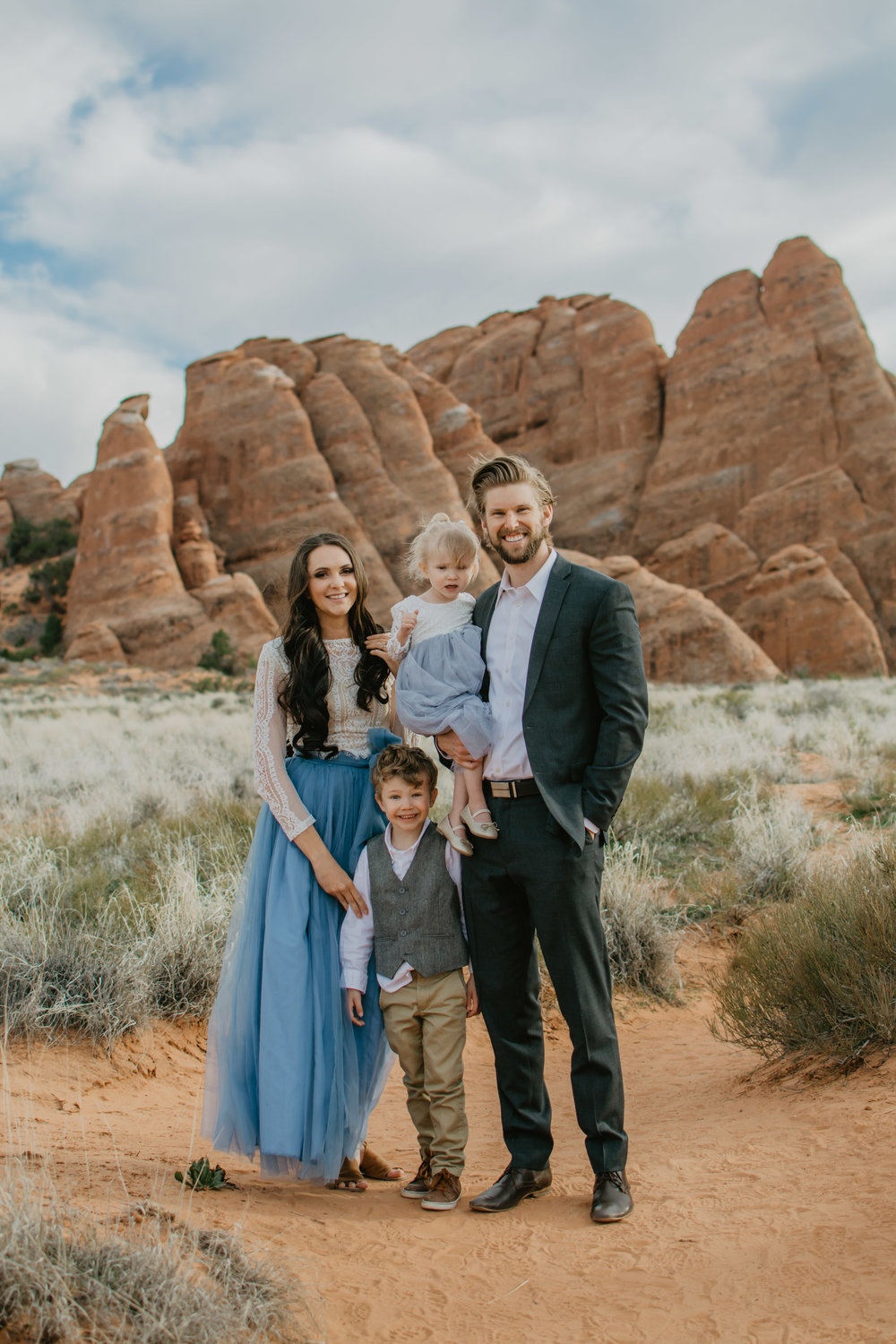 Jocilyn Bennett Photography | Family photo session | Family picture pose ideas | Family portraits | Portrait Photography | Capturing raw and genuine emotion | Utah Photographer | Idaho Photographer | Adventure Photographer | Candid Photography | Candid family poses | Family pictures outfit ideas | Color ideas for family photos | Arches National Park | Family pictures at Arches National Park |
