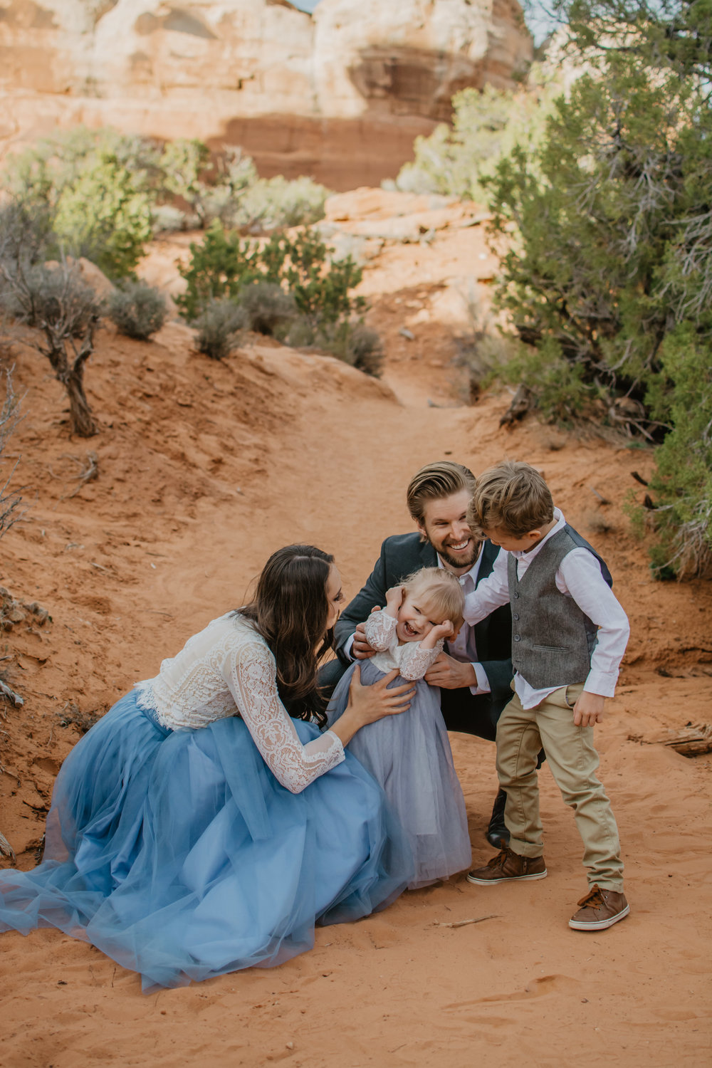 Jocilyn Bennett Photography | Family photo session | Family picture pose ideas | Family portraits | Portrait Photography | Capturing raw and genuine emotion | Utah Photographer | Idaho Photographer | Adventure Photographer | Candid Photography | Candid family poses | Family pictures outfit ideas | Color ideas for family photos | Arches National Park | Family pictures at Arches National Park |