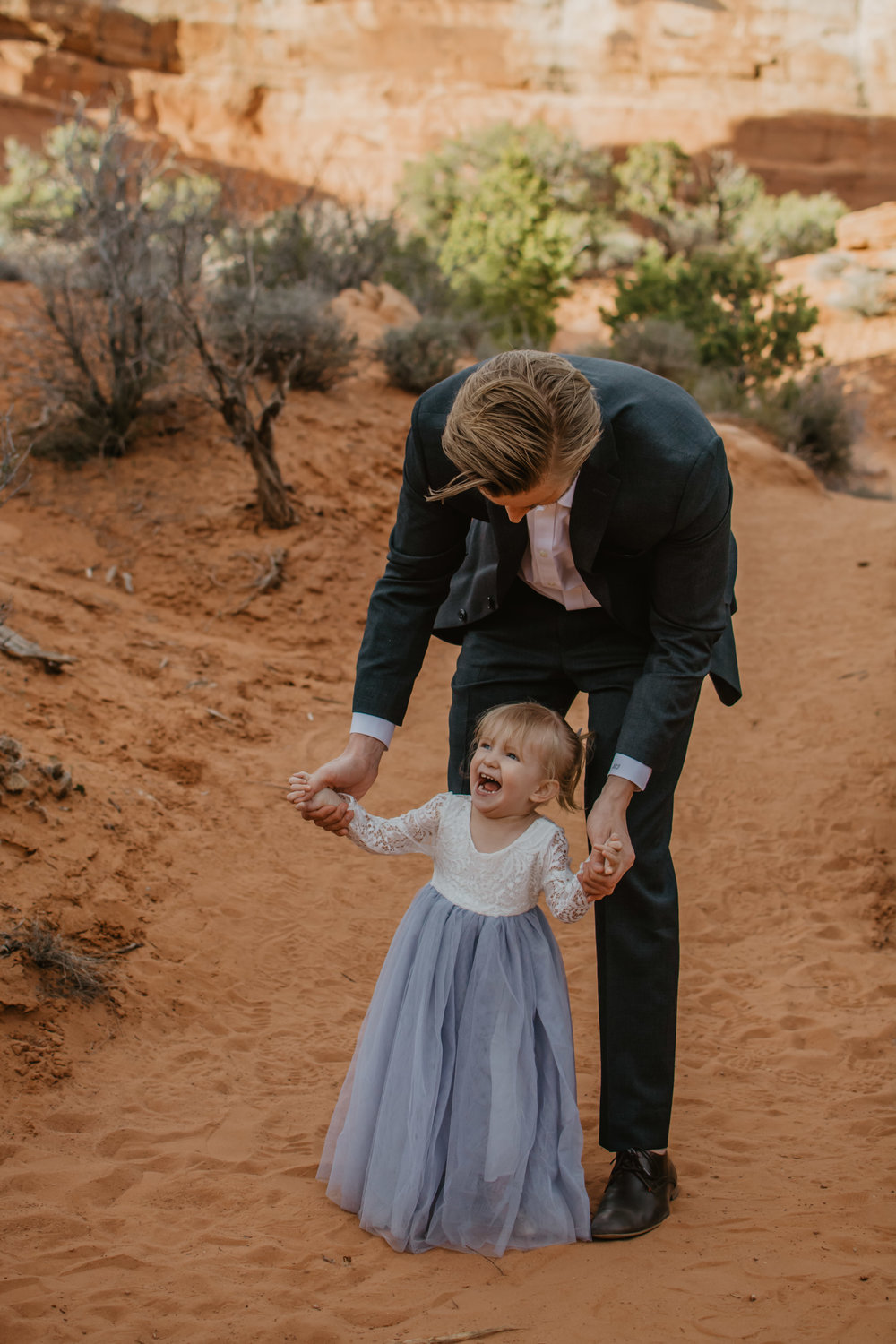 Jocilyn Bennett Photography | Family photo session | Family picture pose ideas | Family portraits | Portrait Photography | Capturing raw and genuine emotion | Utah Photographer | Idaho Photographer | Adventure Photographer | Candid Photography | Candid family poses | Family pictures outfit ideas | Color ideas for family photos | Arches National Park | Family pictures at Arches National Park | Daddy Daughter Pictures |