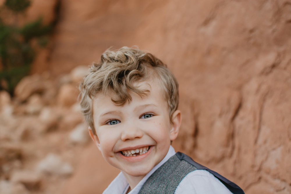 Jocilyn Bennett Photography | Family photo session | Family picture pose ideas | Family portraits | Portrait Photography | Capturing raw and genuine emotion | Utah Photographer | Idaho Photographer | Adventure Photographer | Candid Photography | Candid family poses | Family pictures outfit ideas | Color ideas for family photos | Arches National Park | Family pictures at Arches National Park | Little boy at Aches | Portrait Photography |