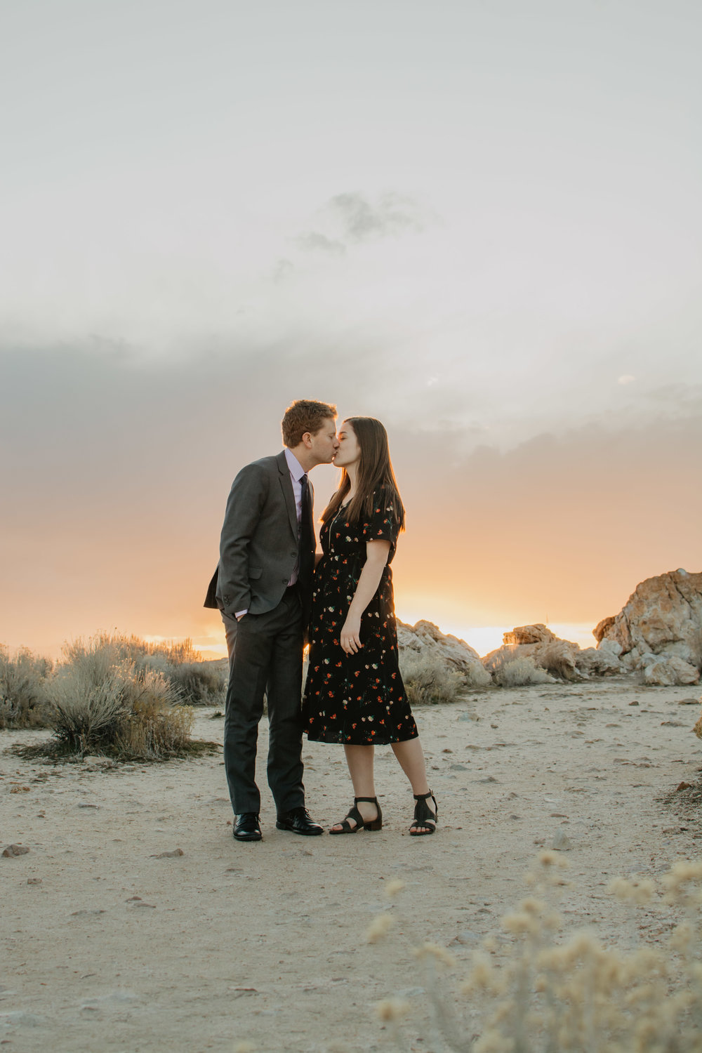 sun setting in Antelope Island for an engagement session with man and woman kissing as the sun sets behind them and the light shines through their hair Jocilyn Bennett Photography | Destination Wedding Photographer | Elopement Wedding Photographer | National Park Elopement Photography | Capturing raw and genuine emotion | Utah Photographer | Utah wedding Photographer | National Park Weddings | Adventure Photographer | Antelope Island Engagements | Engagement pose ideas | Utah engagement photography | Engagement Pose Ideas | Candid Engagements |