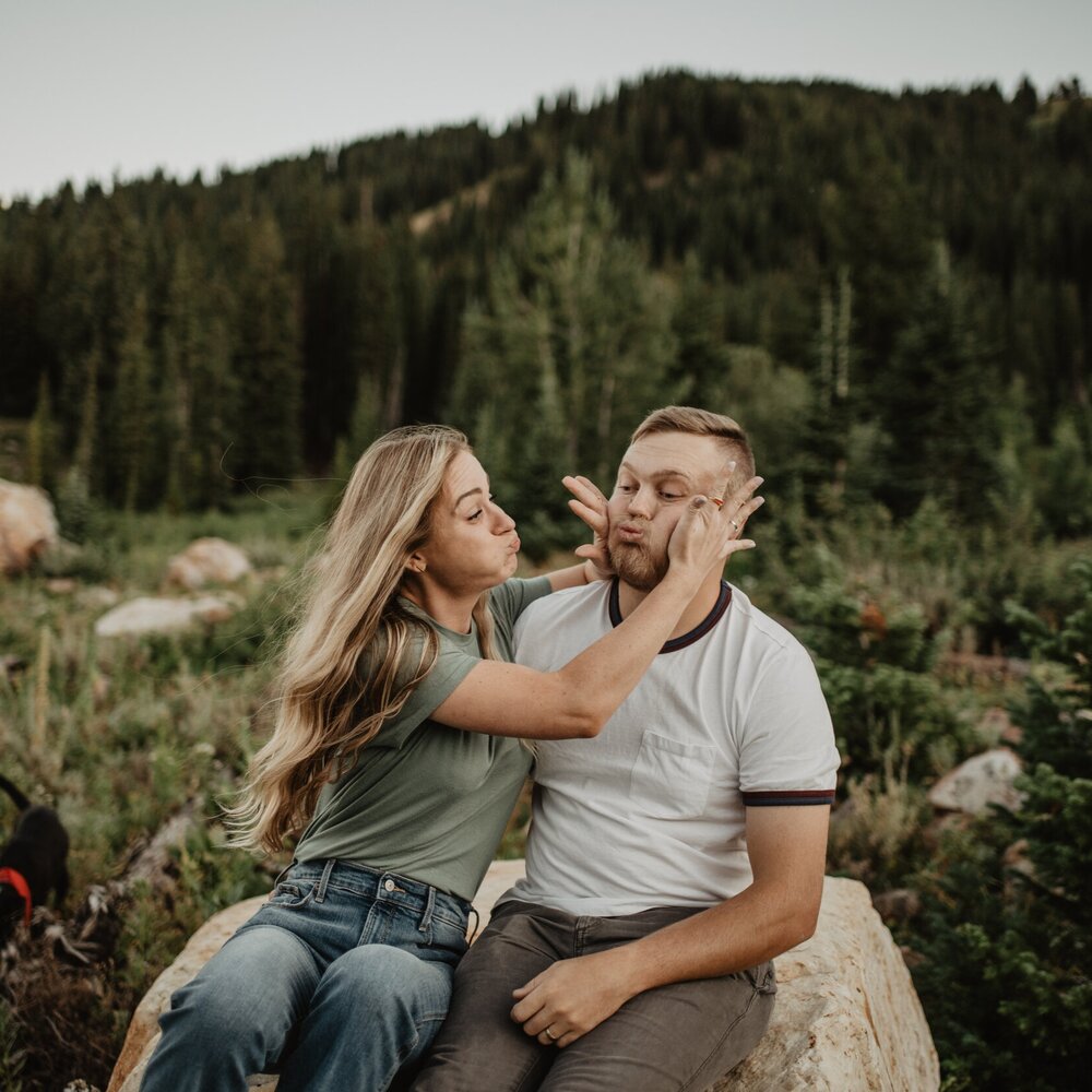 funny engagement photos in Utah in a meadow in the mountains