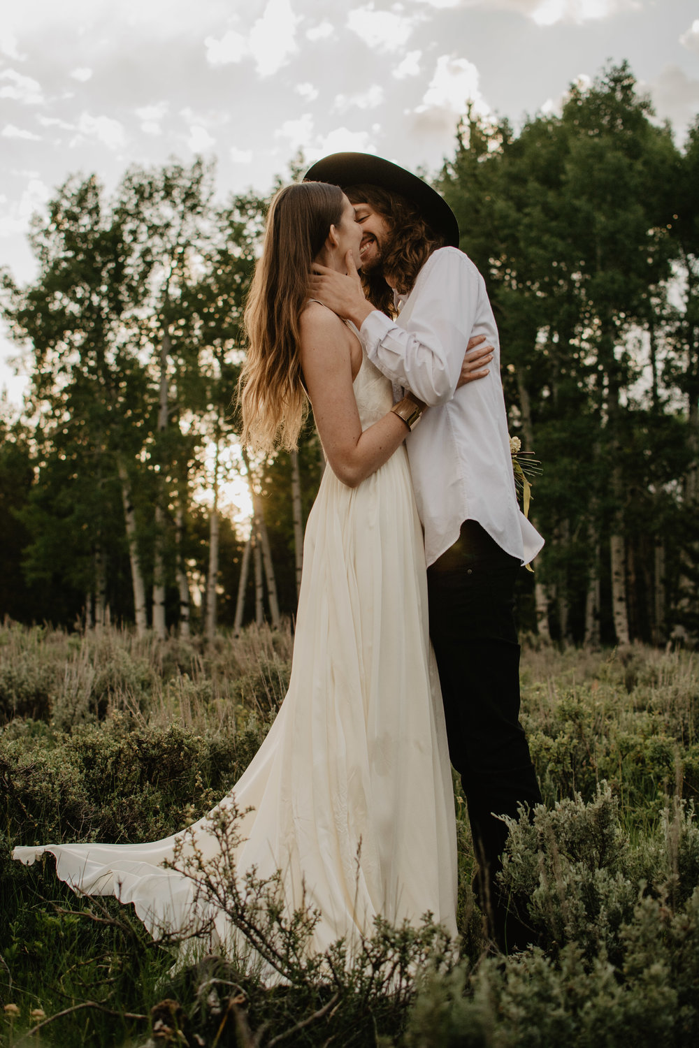 groom kissing his boho bride in the Jackson Hole elopement