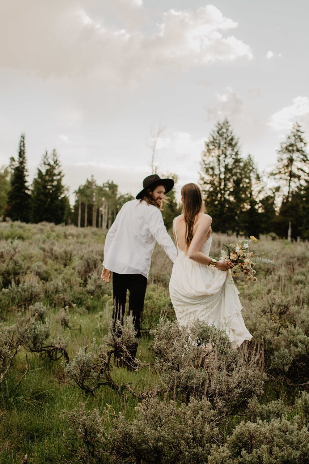 bride and groom having a boho elopement in the Grand Tetons