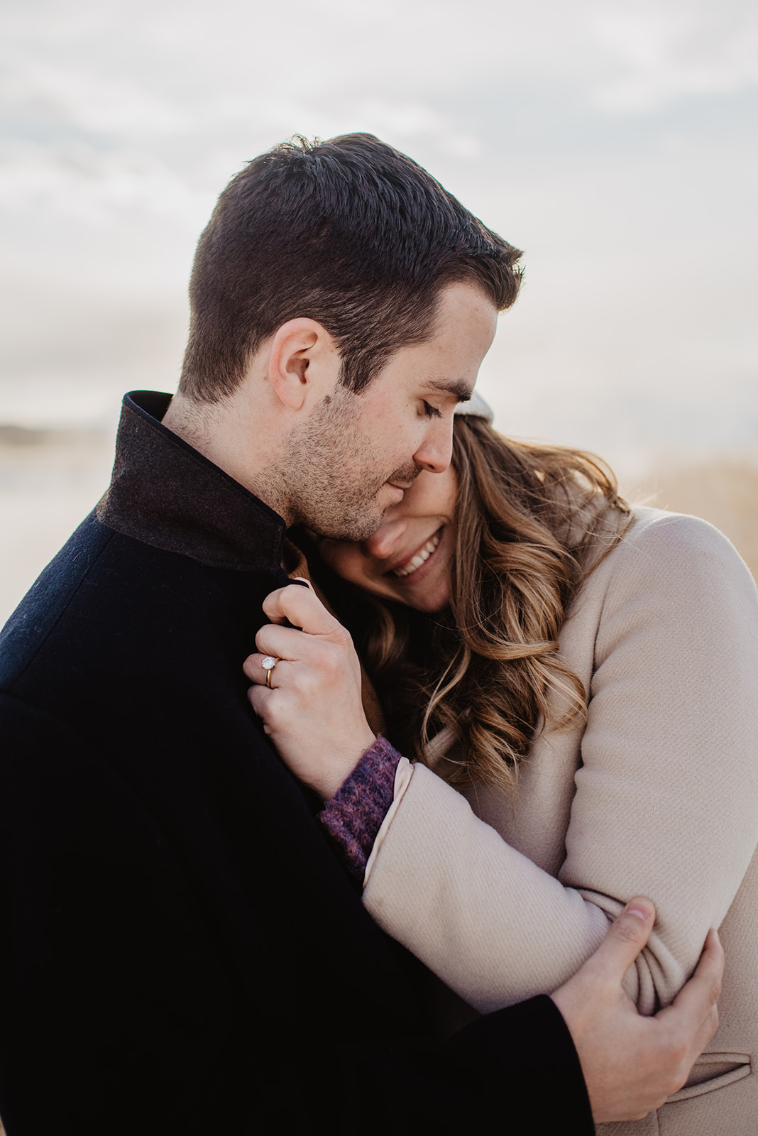 close up of man and woman holding each other for their winter engagement session in Jackson Hole