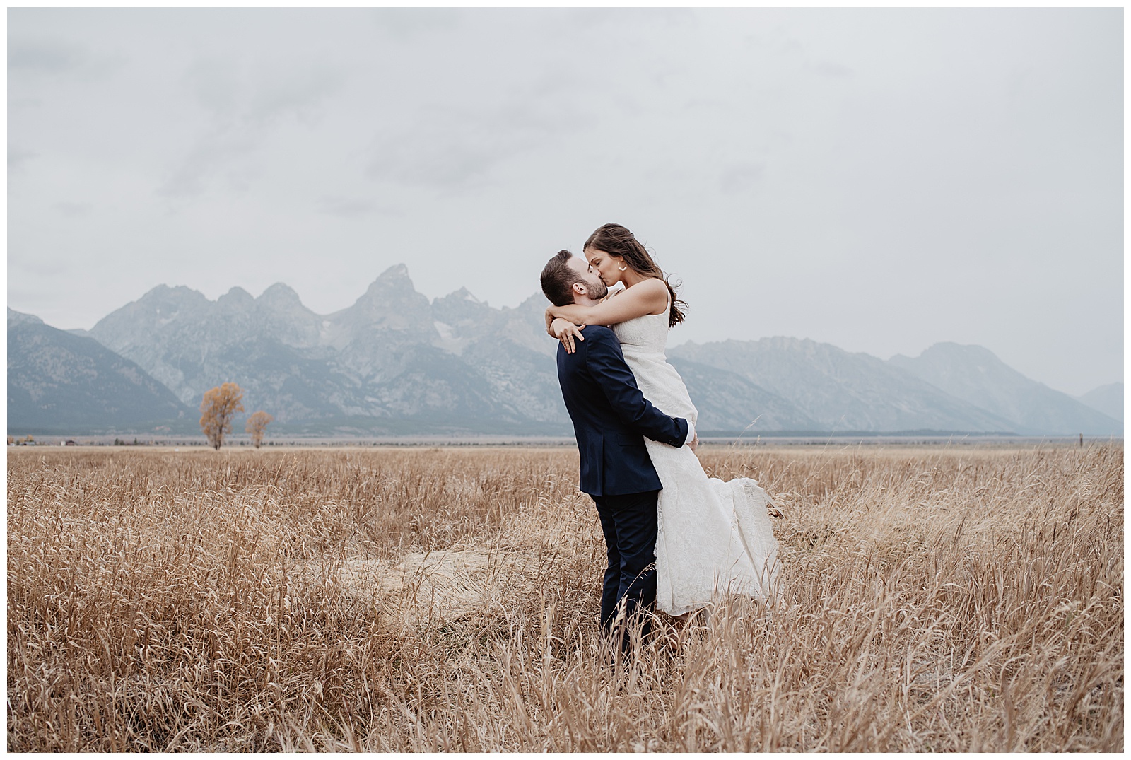 Grassy field wedding photos with the Teton mountains in the background