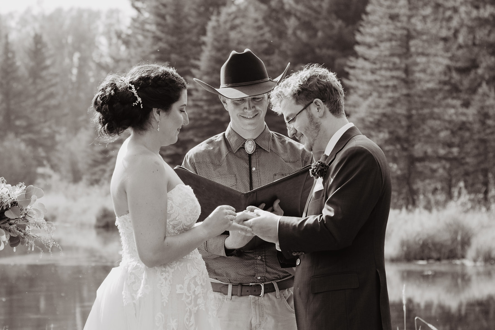 cowboy officiant marries man and woman in Jackson Hole black and white image of wedding day ceremony