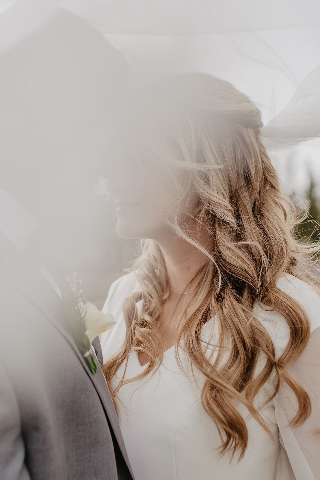bride leaning into groom's face and slightly smiling for a romantic image on their wedding day in Jackson Hole