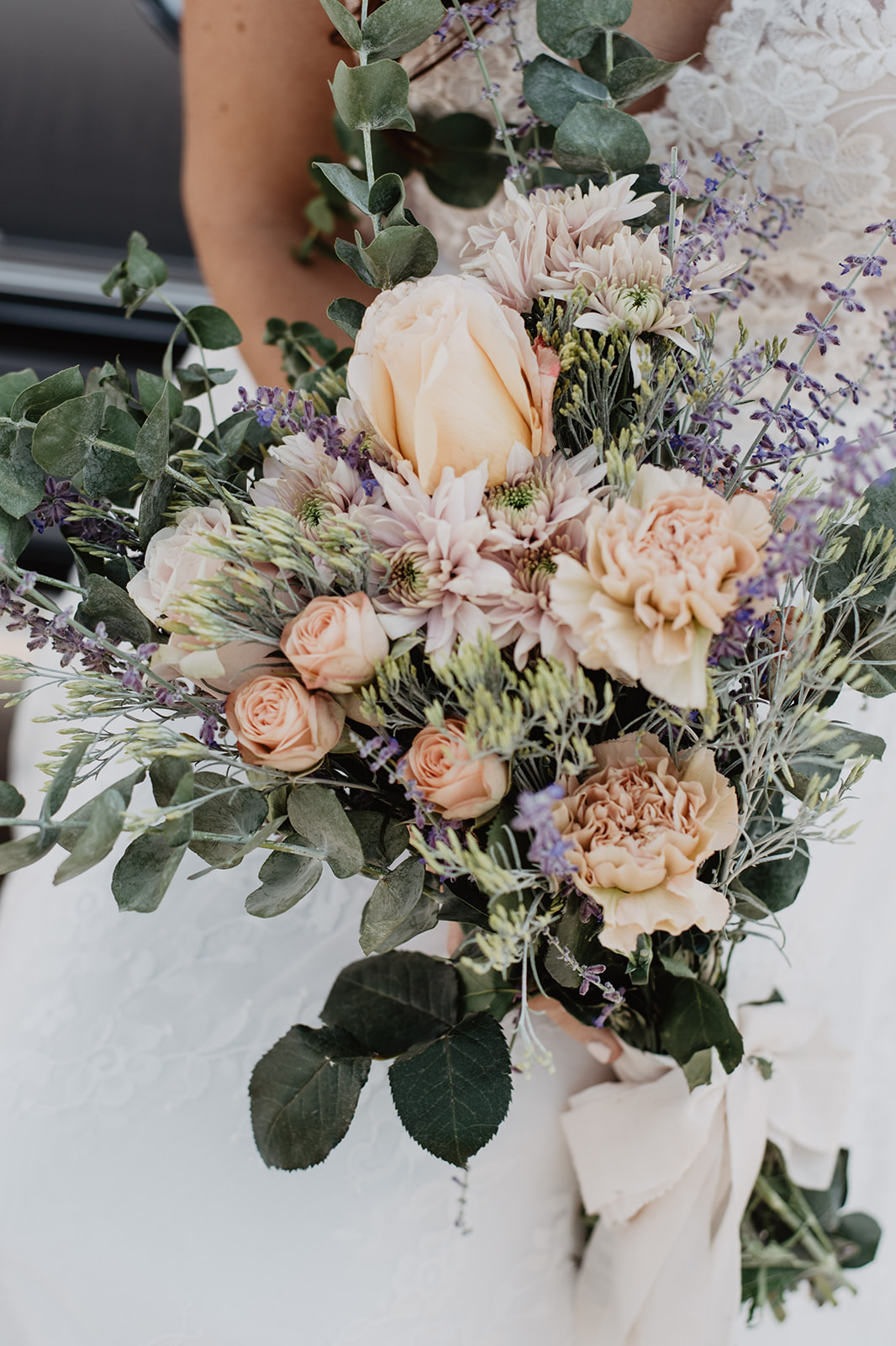 wild flower wedding bouquet that was made by bride and photographer with wild florals, sage, greenery and light pink florals in the Grand Tetons