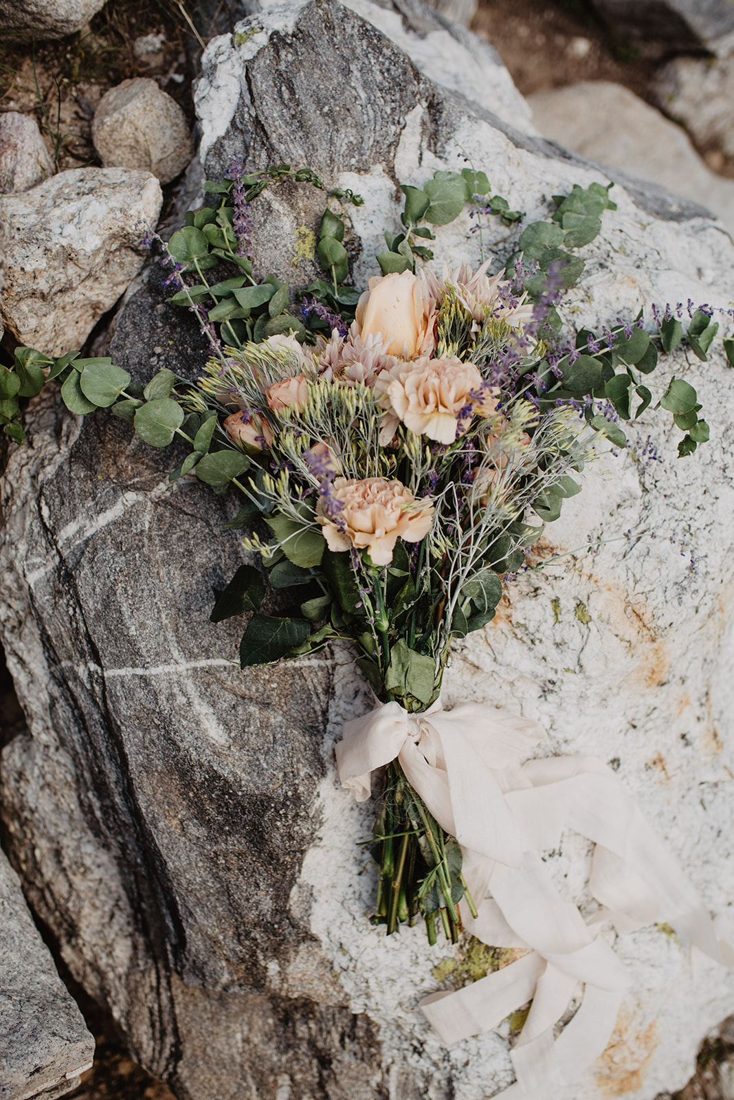 stunning DIY wedding bouquet with a wild and free bohemian style with light pink flowers, sage, and other native greenery