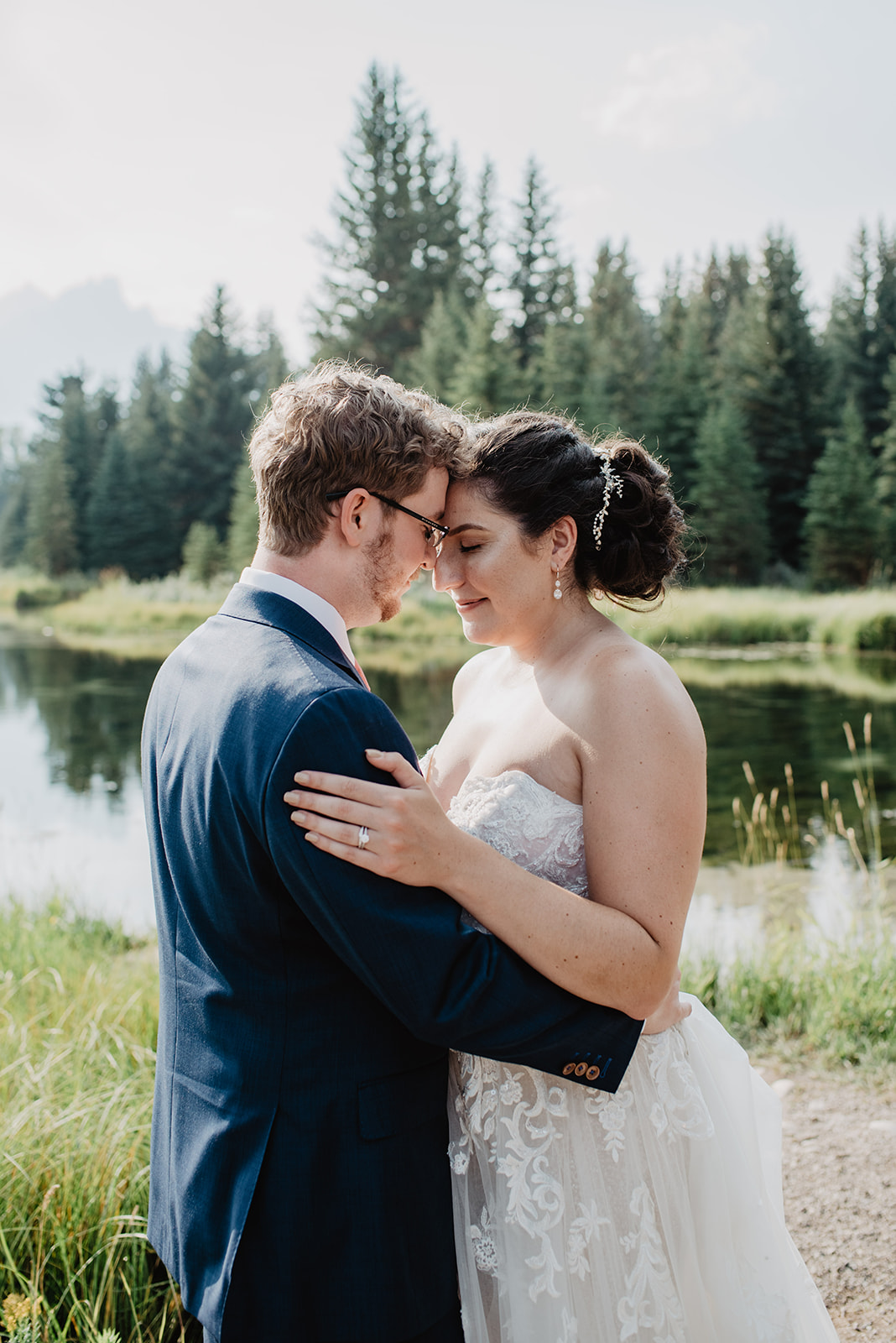 groom holding his bride while they hold their foreheads together for a romantic wedding photo in Jackson Hole captured by the best Jackson Hole wedding and elopement photographer