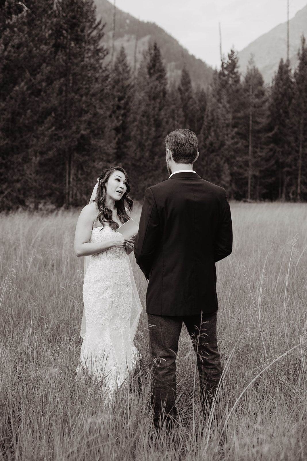 black and white image of bride reading her vows to her groom taken by Grand Tetons National Park Wedding Photographer