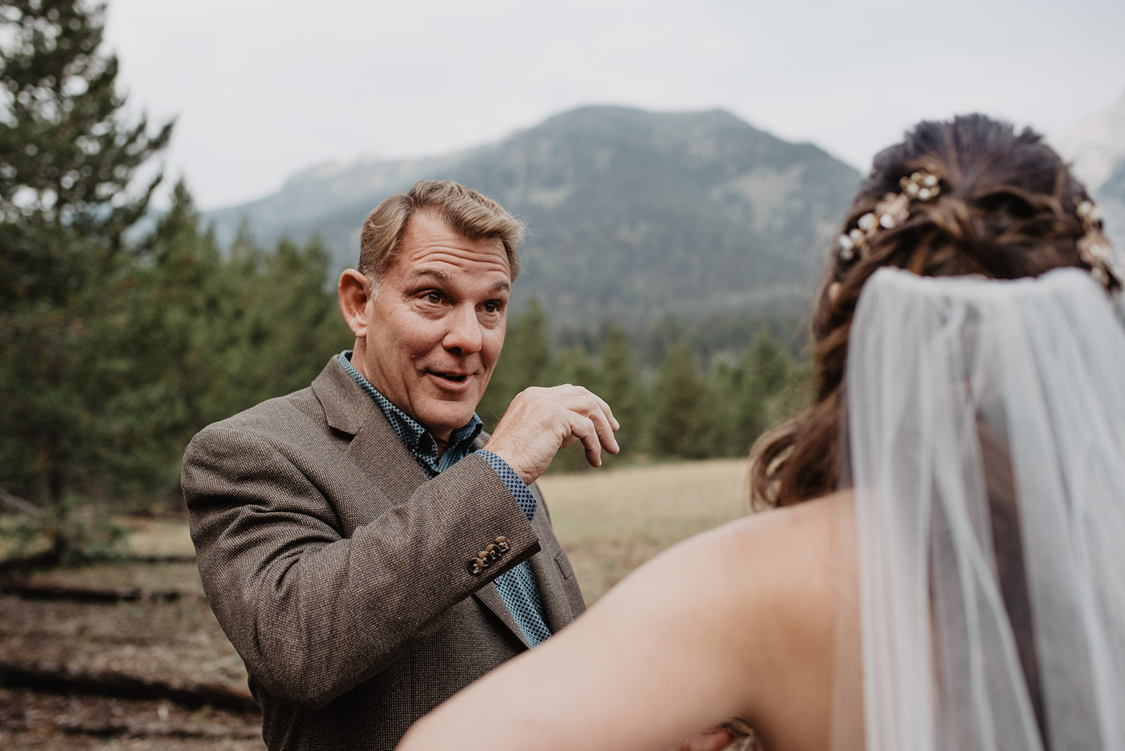 daddy daughter first look on wedding day in the Tetons with dad smiling in surprise