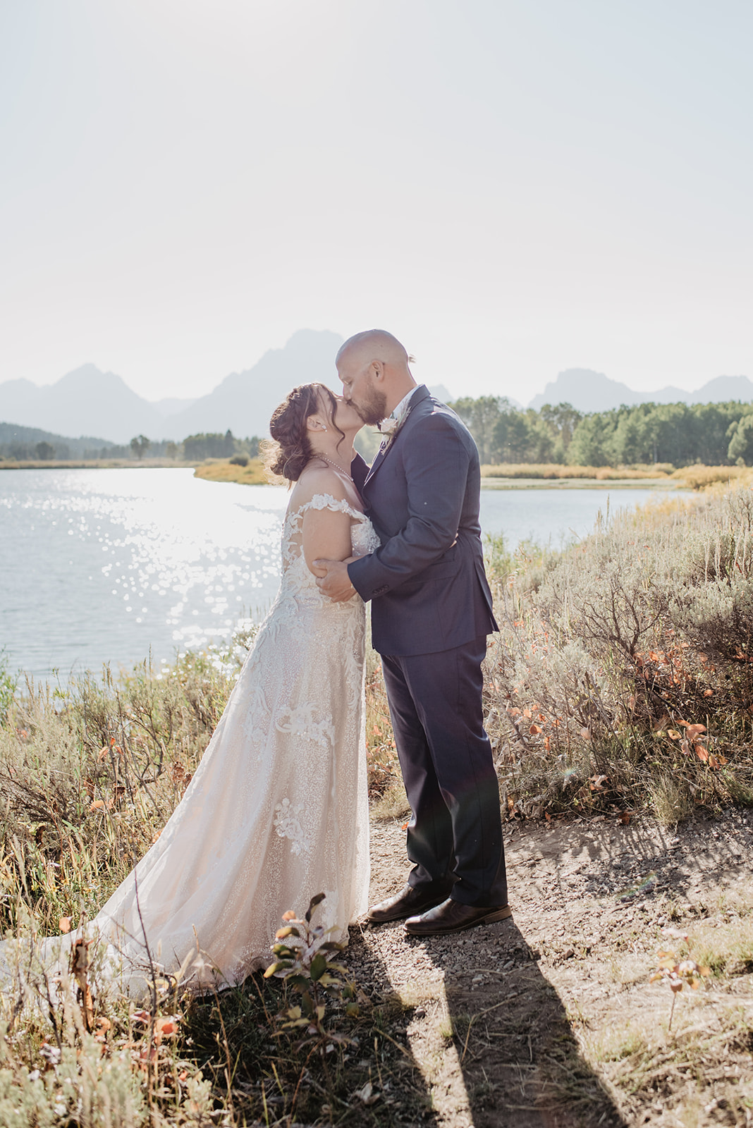 Oxbow Bend wedding with bride and groom kissing in front of the Tetons captured by best Jackson Hole wedding photographers 