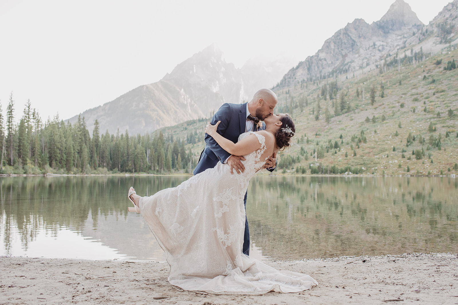 groom dipping his bride at String Lake for their Jackson Hole elopement