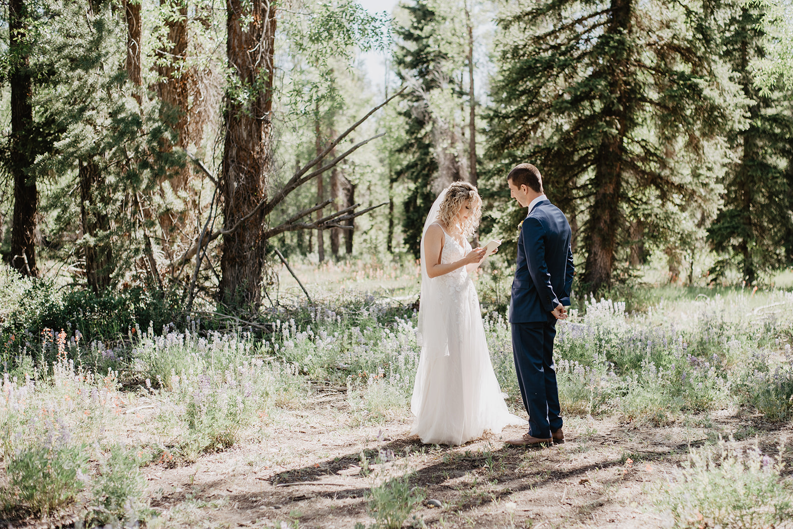 bridals in the woods of JAckson HOle with the bride and groom sharing their private vow to oneanother for their Spring wedding