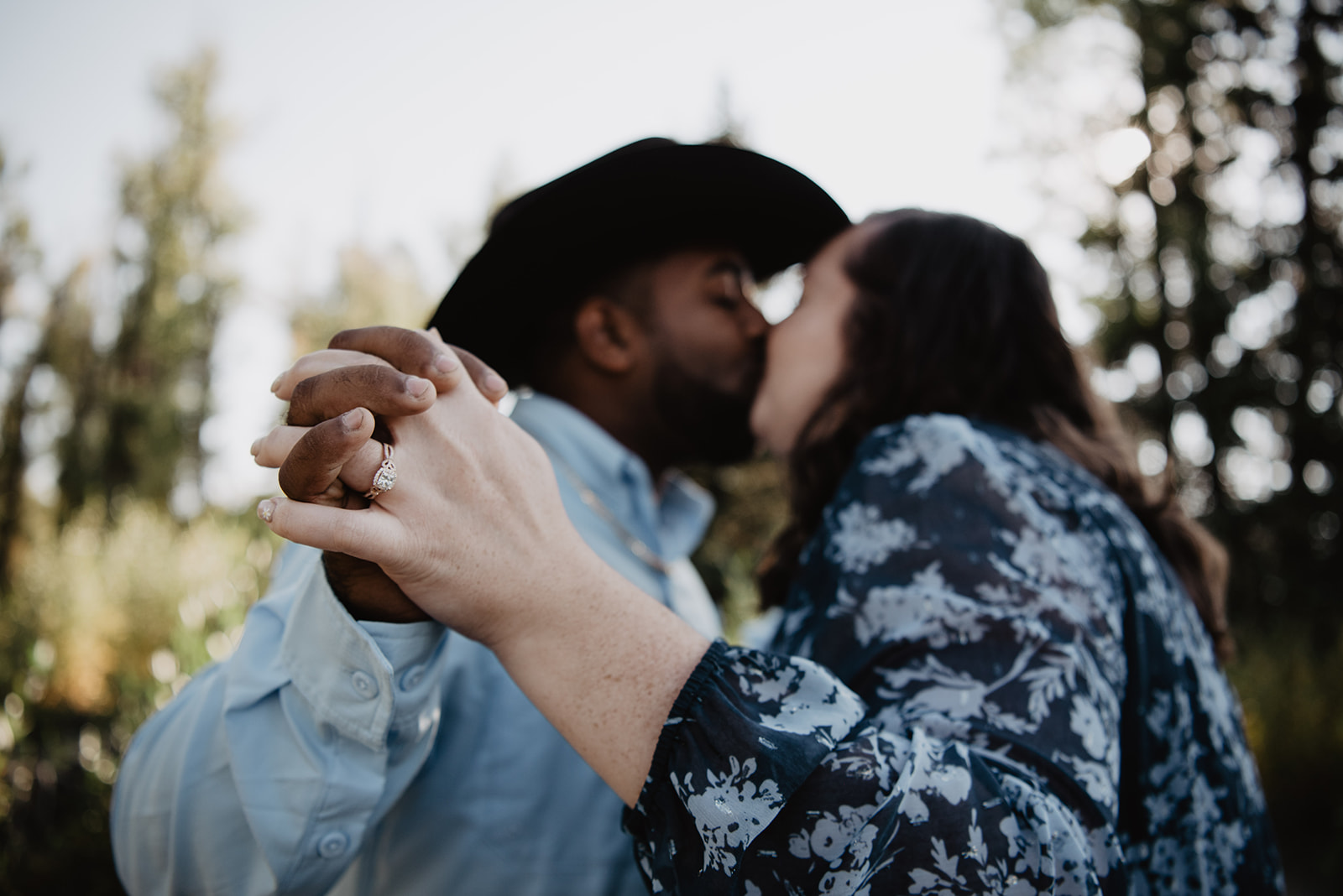 detail shot of engagement ring during an engagement photoshoot while the couple hold hands, dance and kiss in Jackson Hole for a National Park surprise proposal