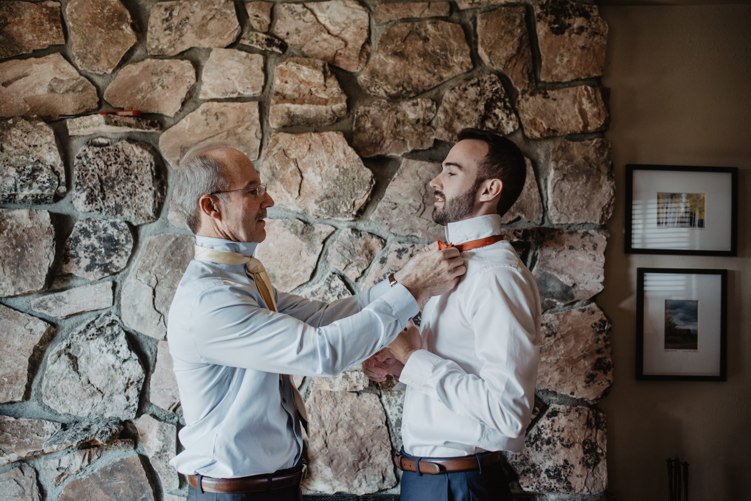 groom getting ready the morning of his elopement with his father helping him with his tie