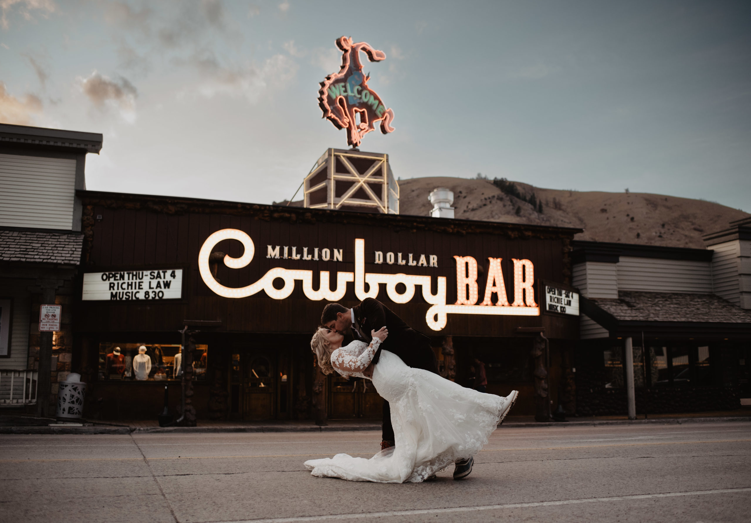 Jackson Hole elopement with groom dipping his bride in front of the famous Cowboy Bar in Jackson Hole 