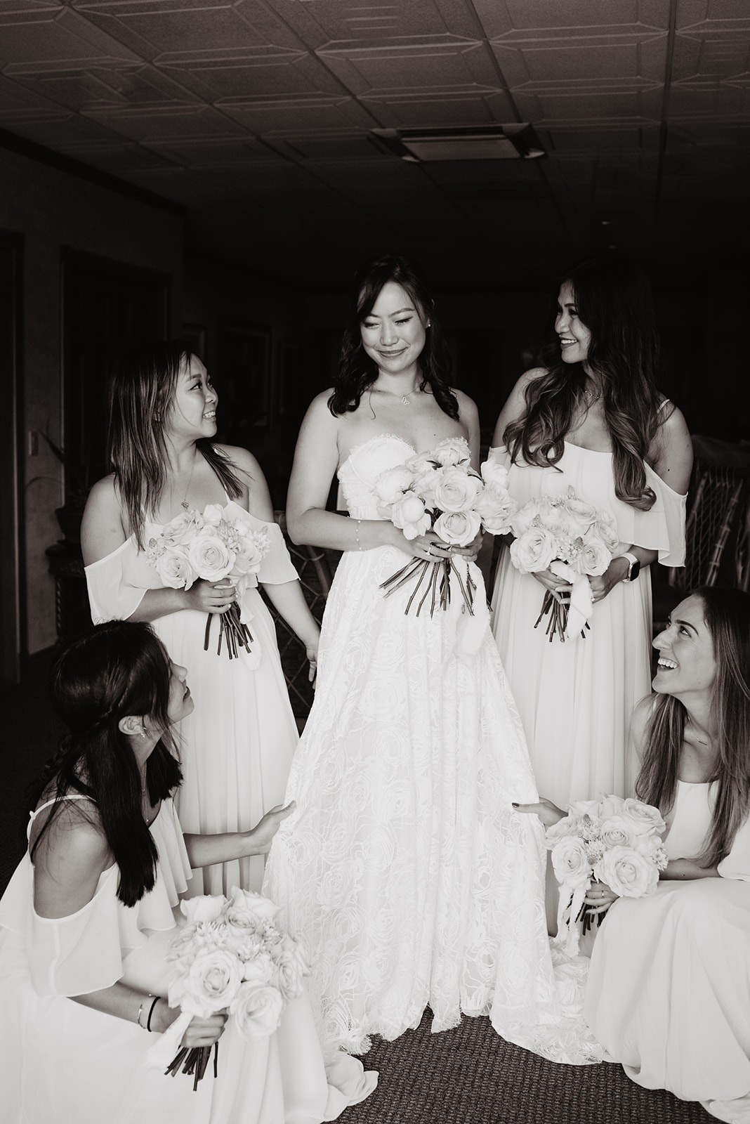 black and white image of a bride with her bridesmaids posing in a bridal suite at a Jackson Hole wedding venue