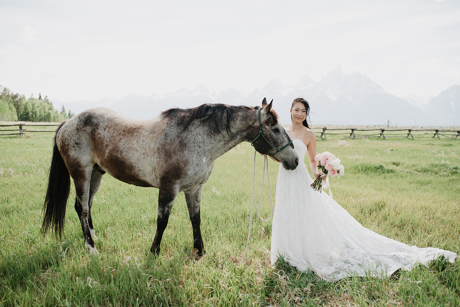 bride standing with a horse at a wedding venue in Jackson Hole for her outdoor wedding with Jackson Hole wedding photographer
