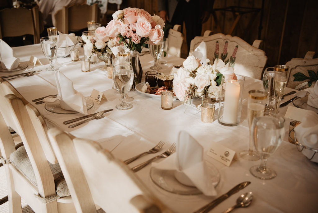Jackson Hole wedding table decor with roses and glass tableware