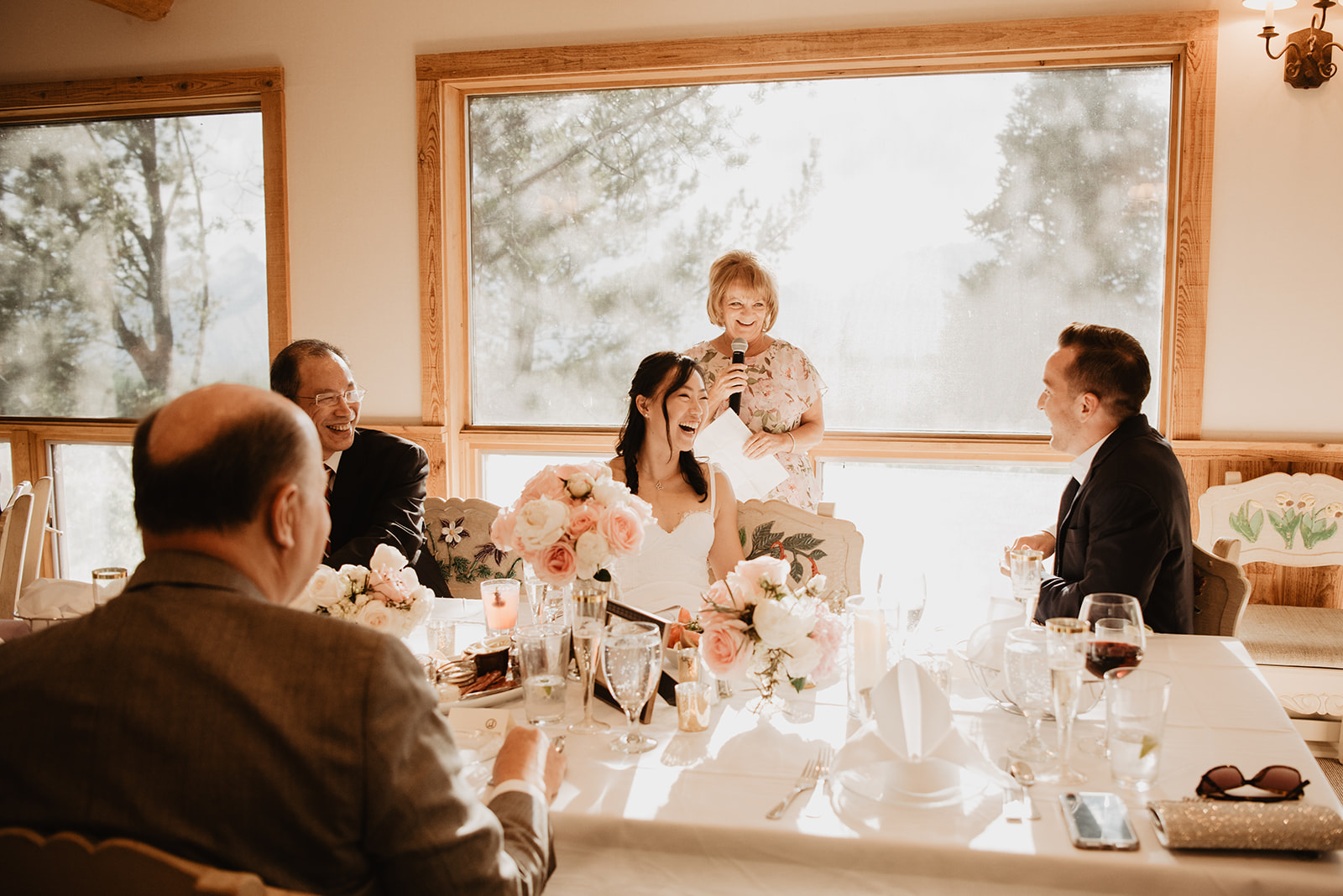 bride and groom laughing at a toast during their private wedding reception at a Jackson Hole wedding venue