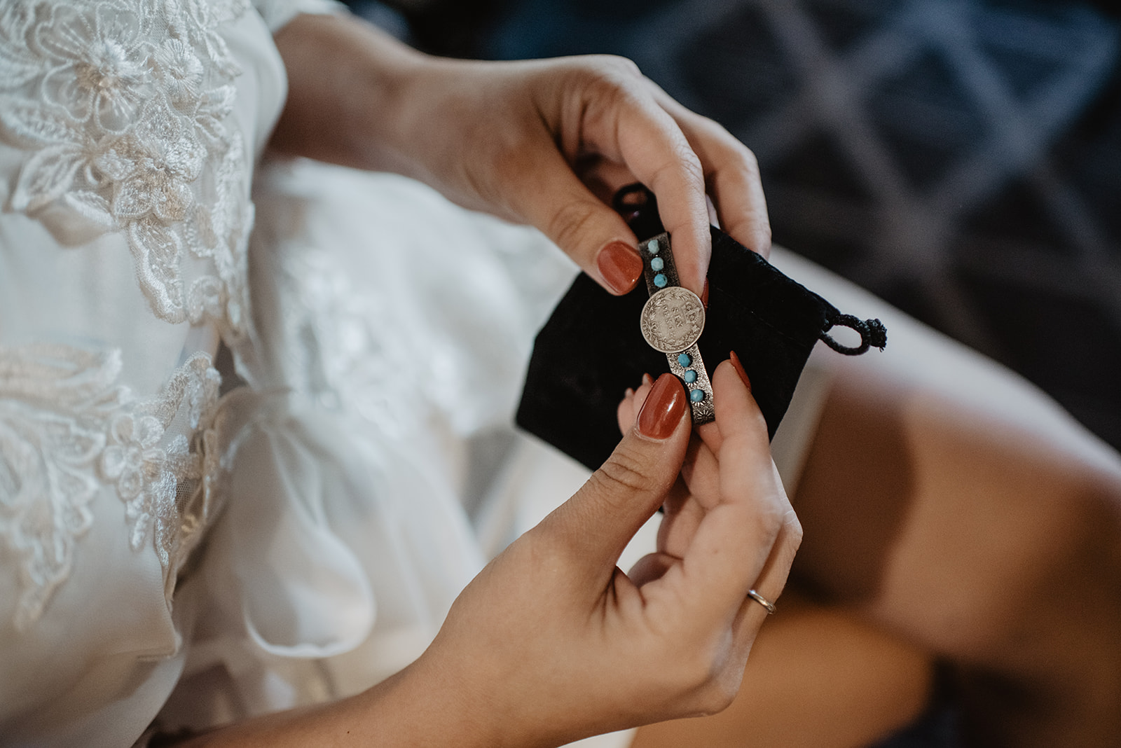 bride holding a turquoise bracelet as she gets ready for her Jackson Hole wedding
