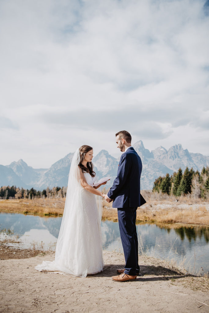 bride reading a letter to her groom before their wedding ceremony in Jackson Hole