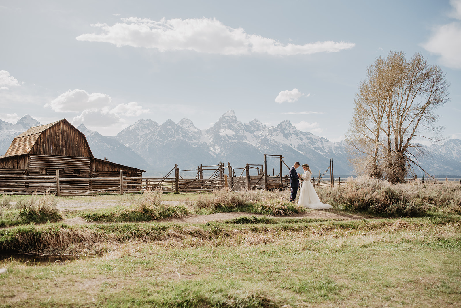 Grand Teton wedding photographer captured bride and groom at Mormon Row in the Tetons on their Spring elopement day captured by best Grand Teton Wedding Photographer