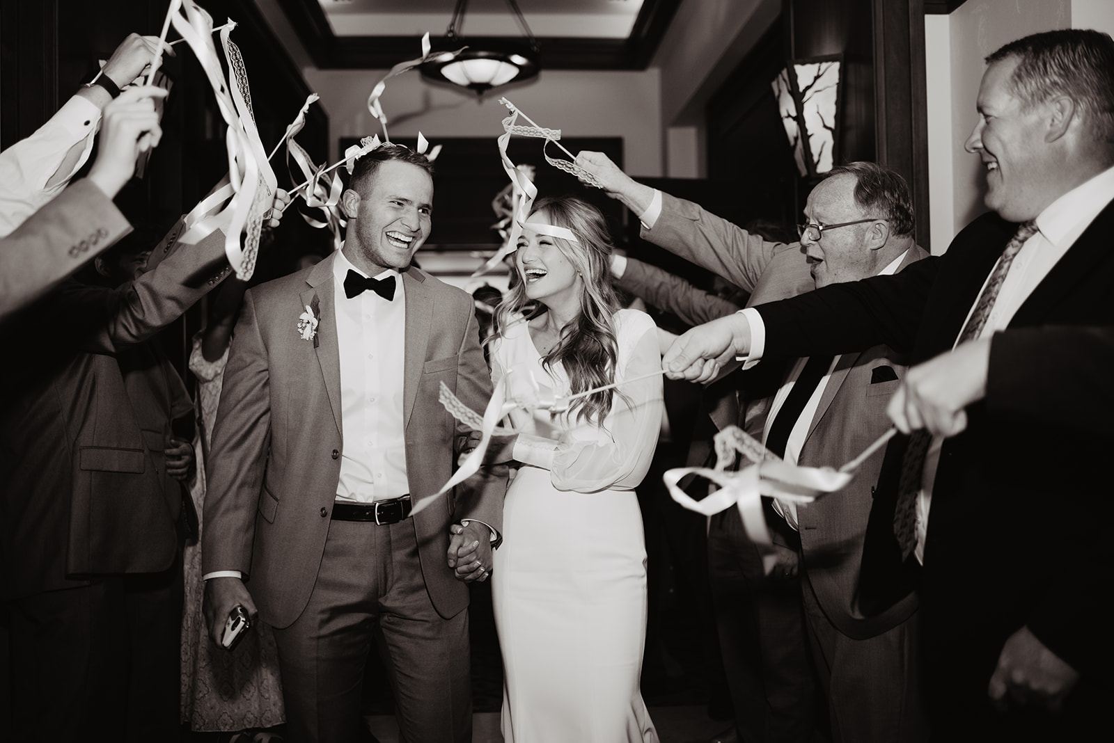 grand exit at the end of the wedding reception with white streamers surrounding the couple at Four Seasons Jackson Hole wedding