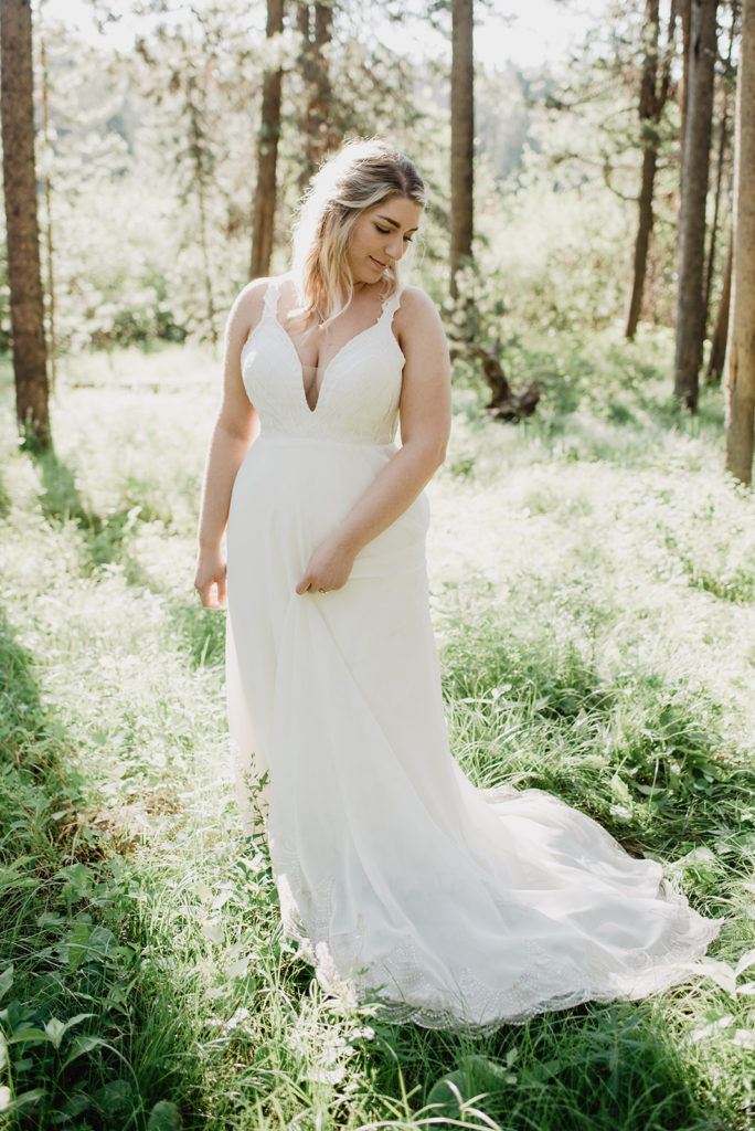 Jackson Hole elopement locations in the woods with bride in a meadow surrounded by tall trees in the spring 