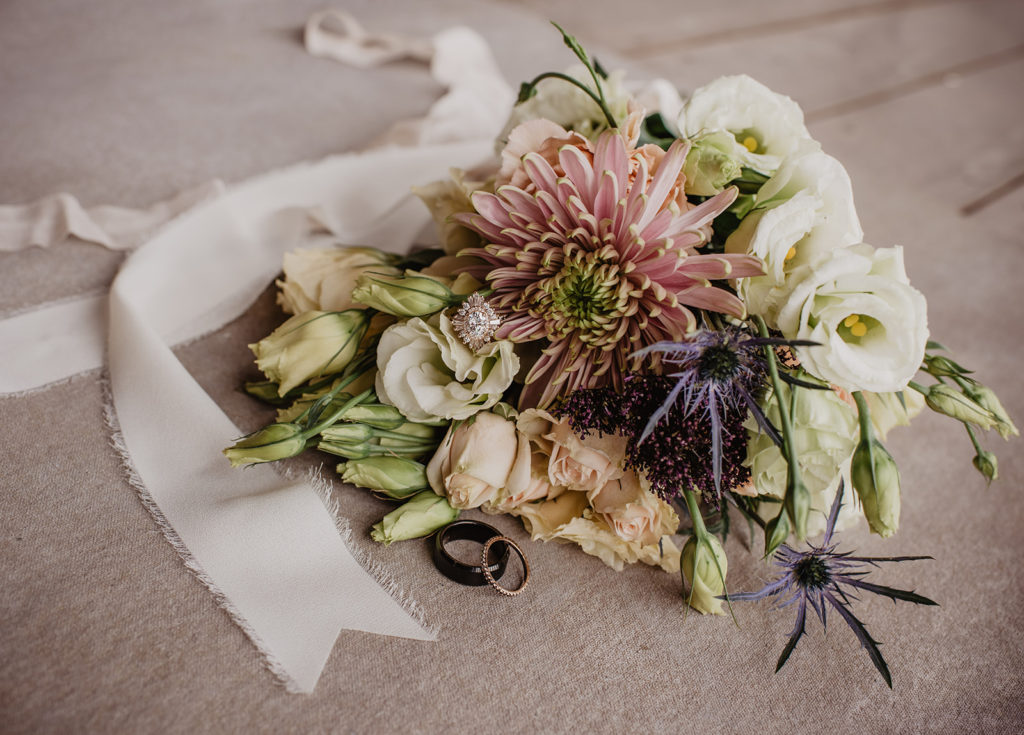 wedding bouquet made of blush florals in a white ribbon arranged by Jackson Hole photographers