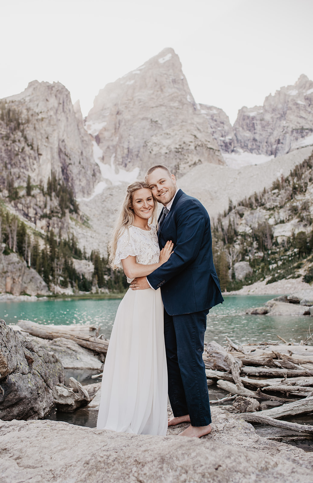 Jackson Hole wedding picture with bride and groom embracing in front of the Tetons for their Grand Teton wedding