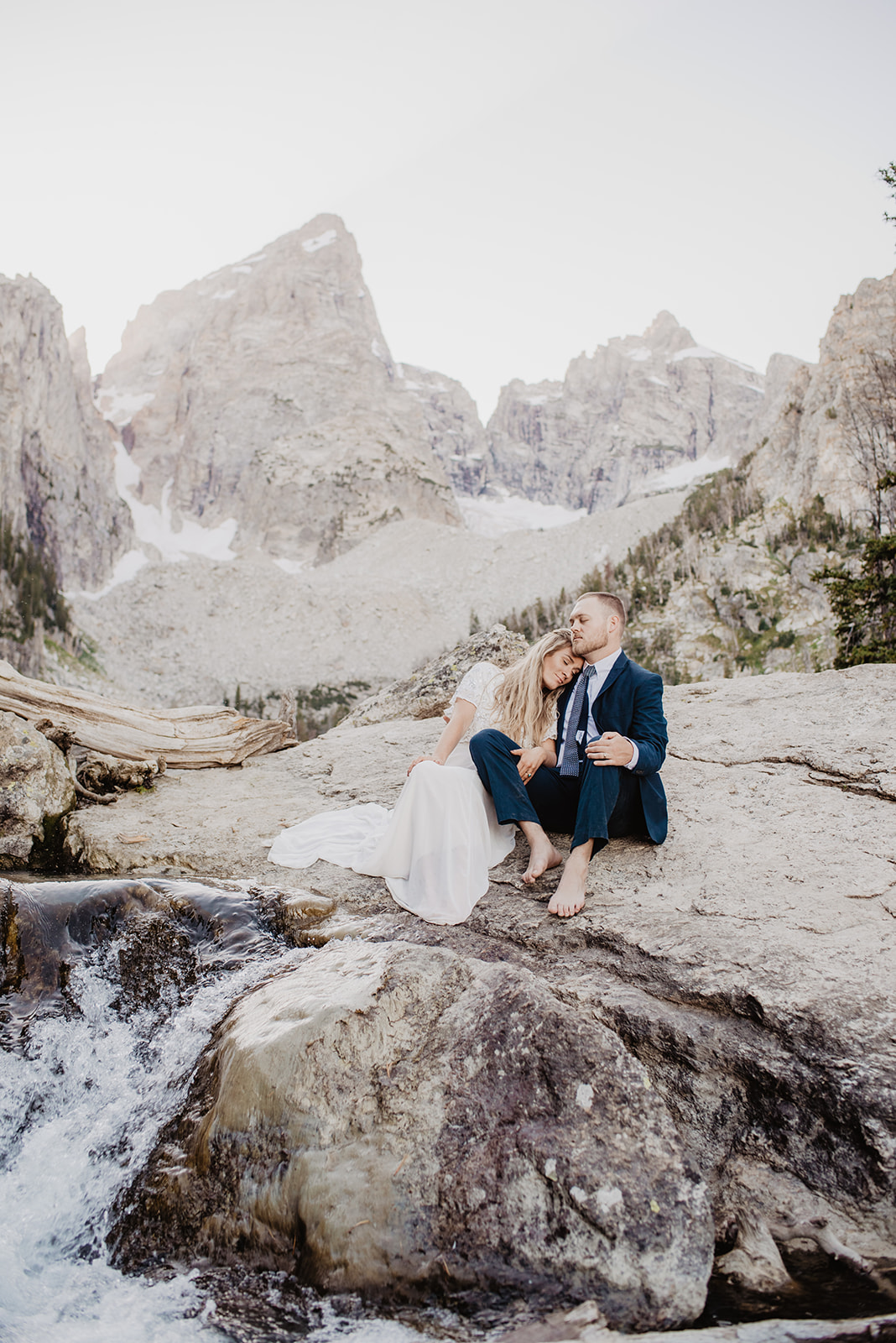 romantic wedding photos in the Grand Tetons captured by Jackson Hole wedding photographer of bride and groom at Delta Lake