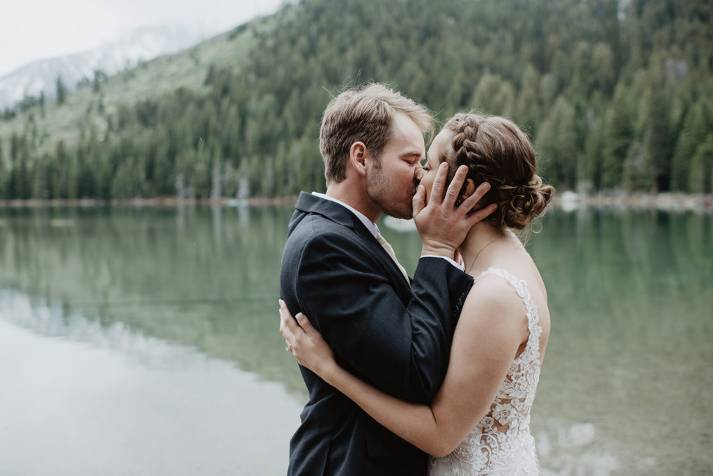 bride and groom kissing passionately while at string lake in Jackson Hole capture by elopement photographer