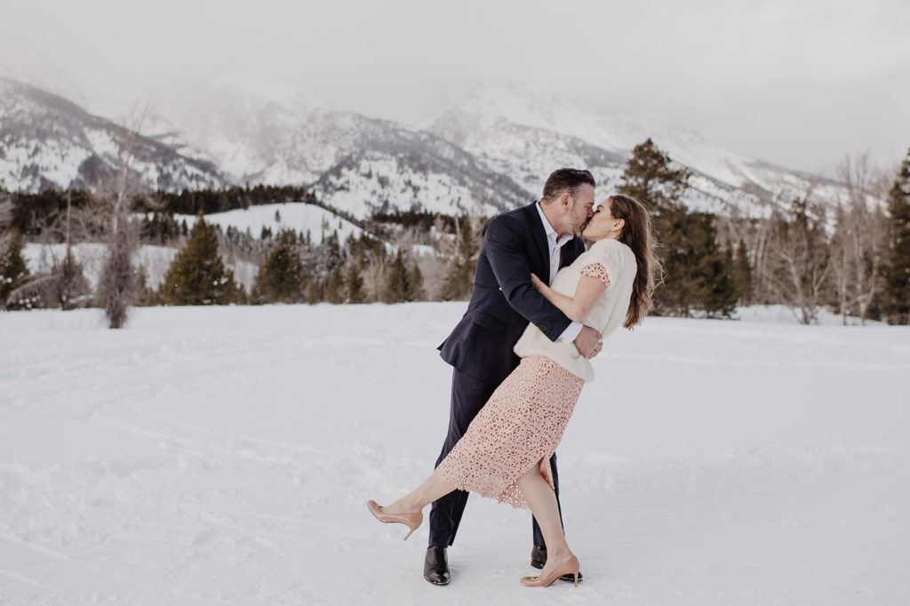 groom dipping his brade backwards for their winter wedding pictures in Jackson Hole 