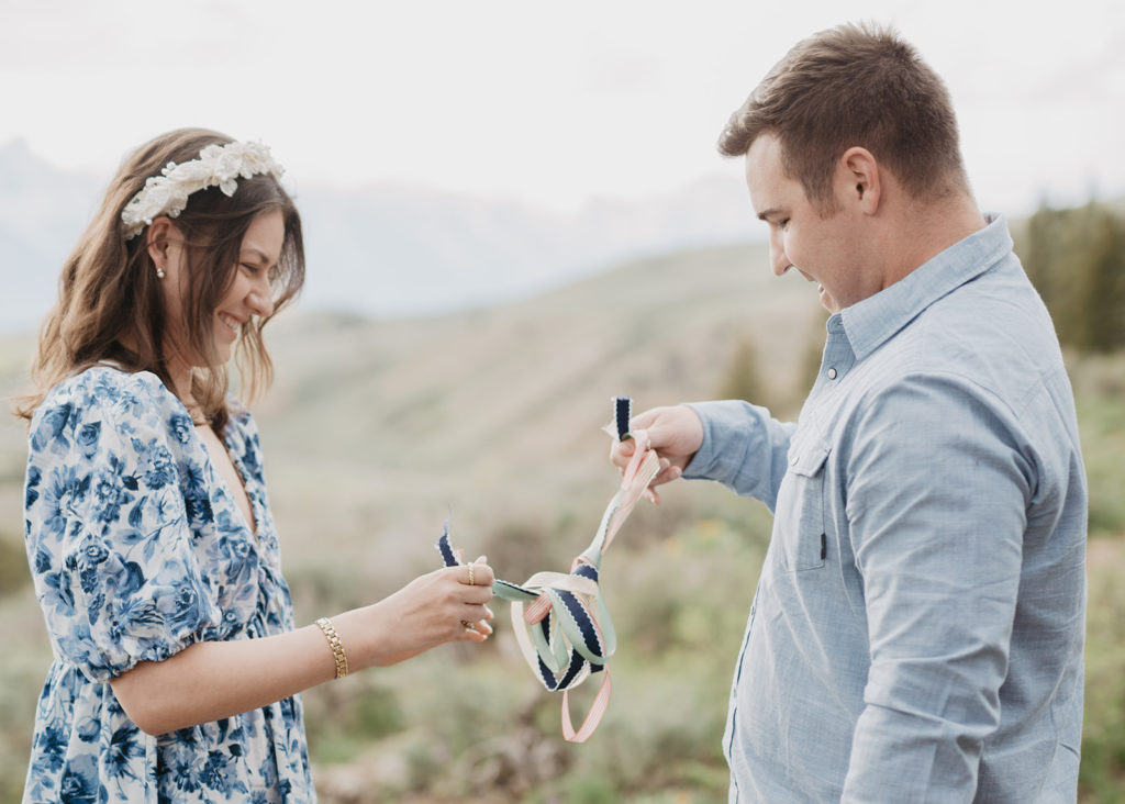 bride and groom tying a knot of rides together for their unique wedding ceremony tradition with Jackson Hole wedding photographers 