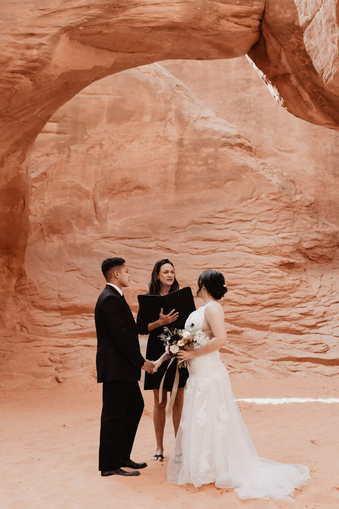 Utah Elopement Photographer captures bride and groom holding hands during intimate elopement ceremony