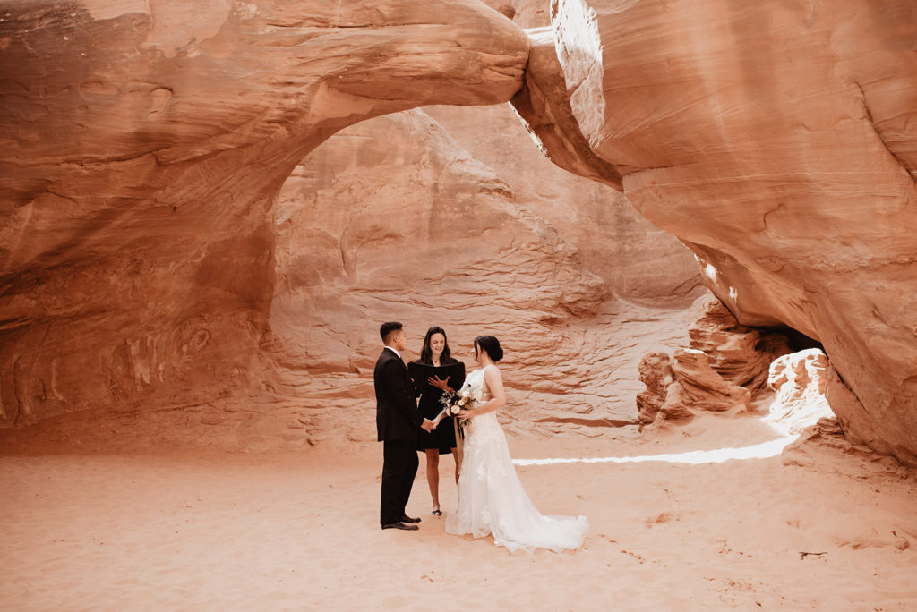 Utah Elopement Photographer captures bride and groom during red rocks elopement ceremony