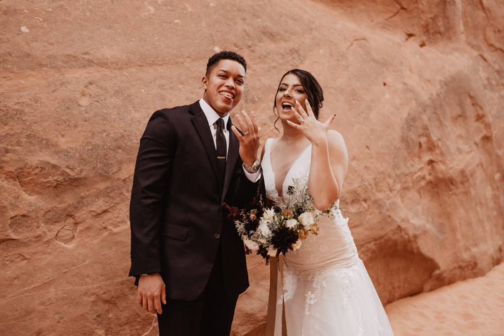 Utah elopement photographer captures couple showing wedding rings after recent elopement