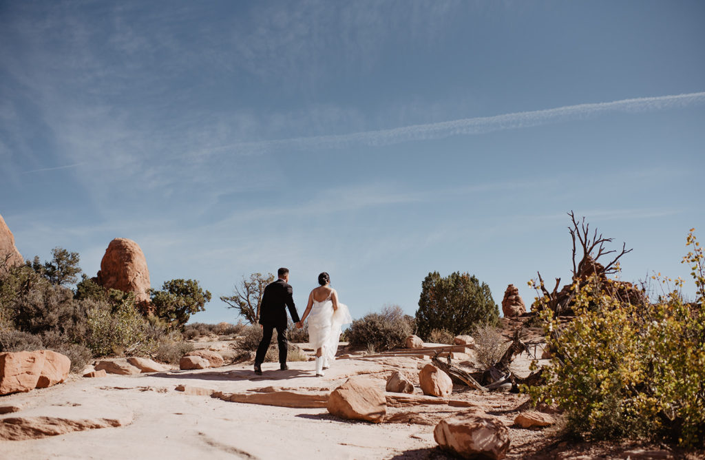 Utah Elopement Photographer captures bride and groom walking hand in hand