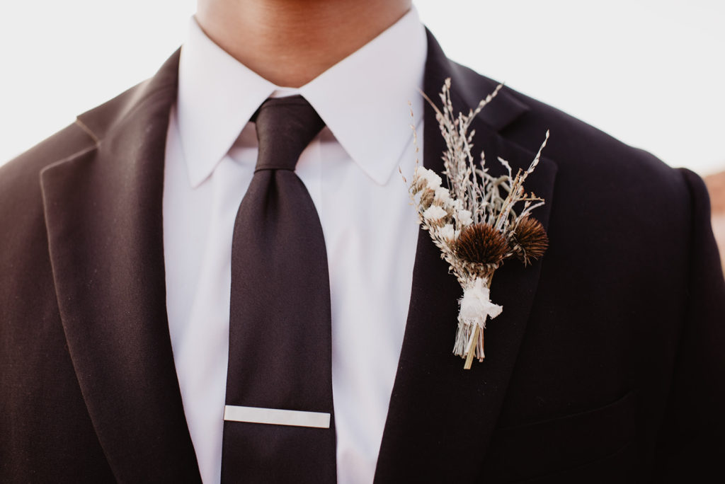 Utah elopement photographer captures close up of groom details and boutonniere 