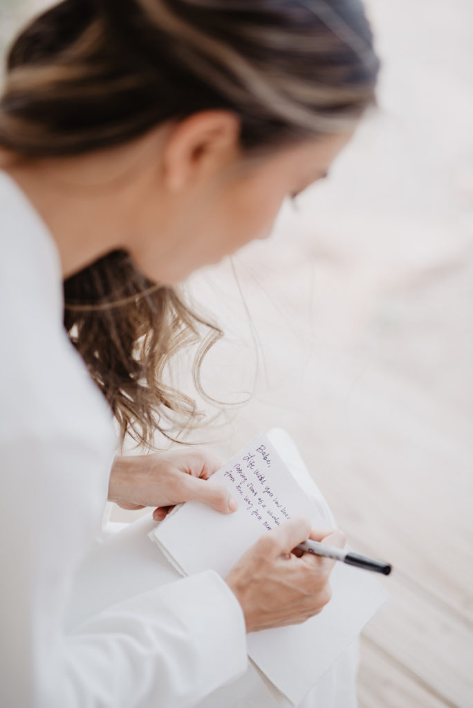 bride writing a sweet love note to her groom the morning of their wedding captured by Utah elopement photographer 