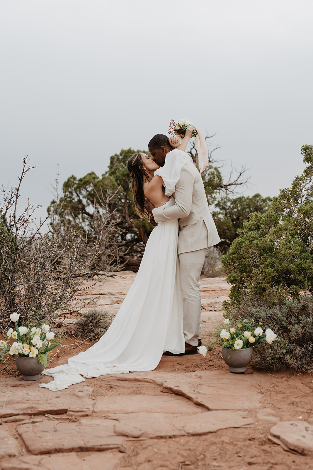 first kiss as bride and groom for their Arches National Park wedding captured by Utah Elopement Photographer