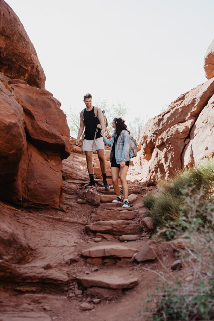 Utah elopement photographer captures couple walking hand in hand in Moab